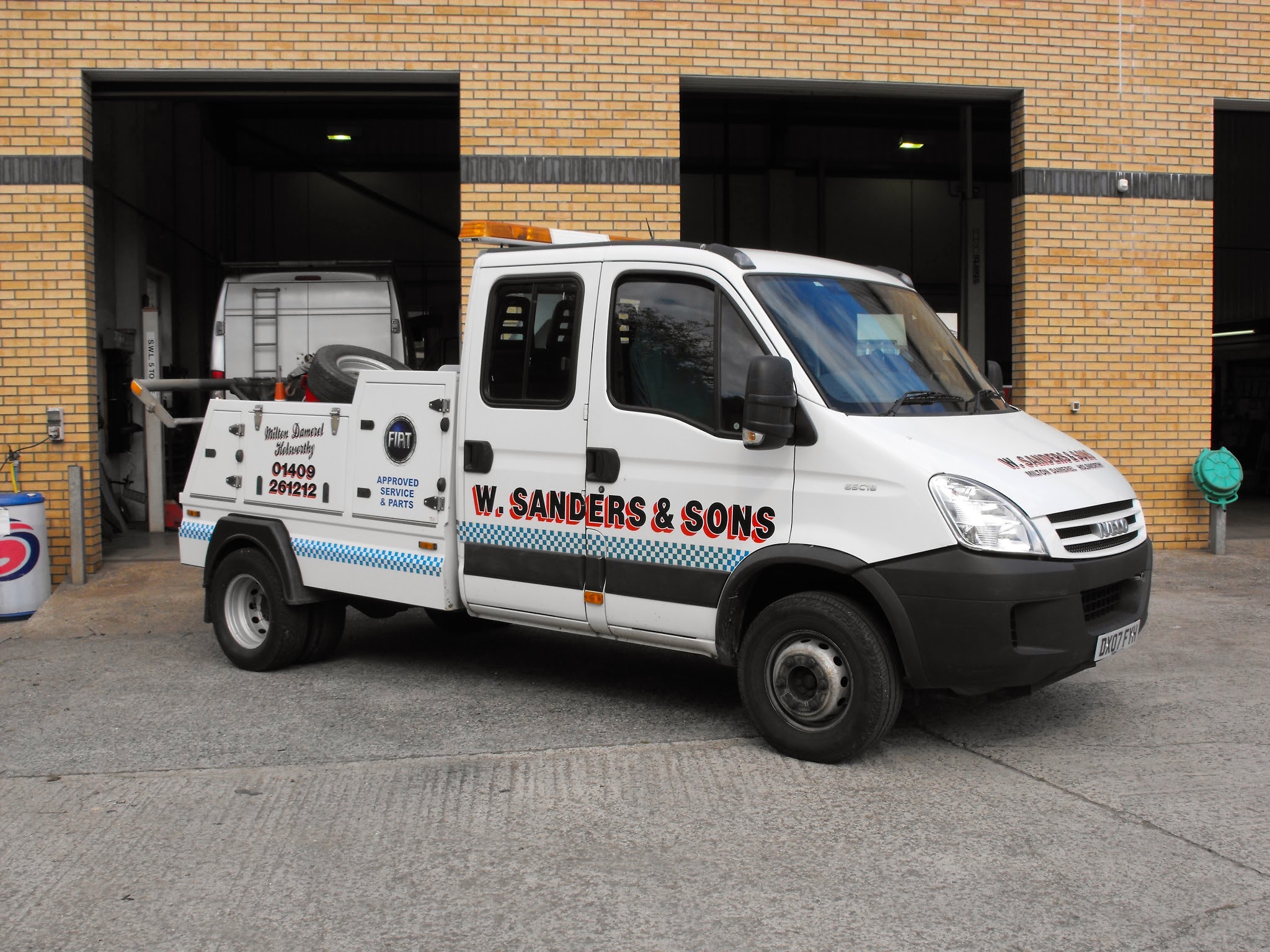 The W Sanders & Sons recovery truck in its blue and white chequered livery