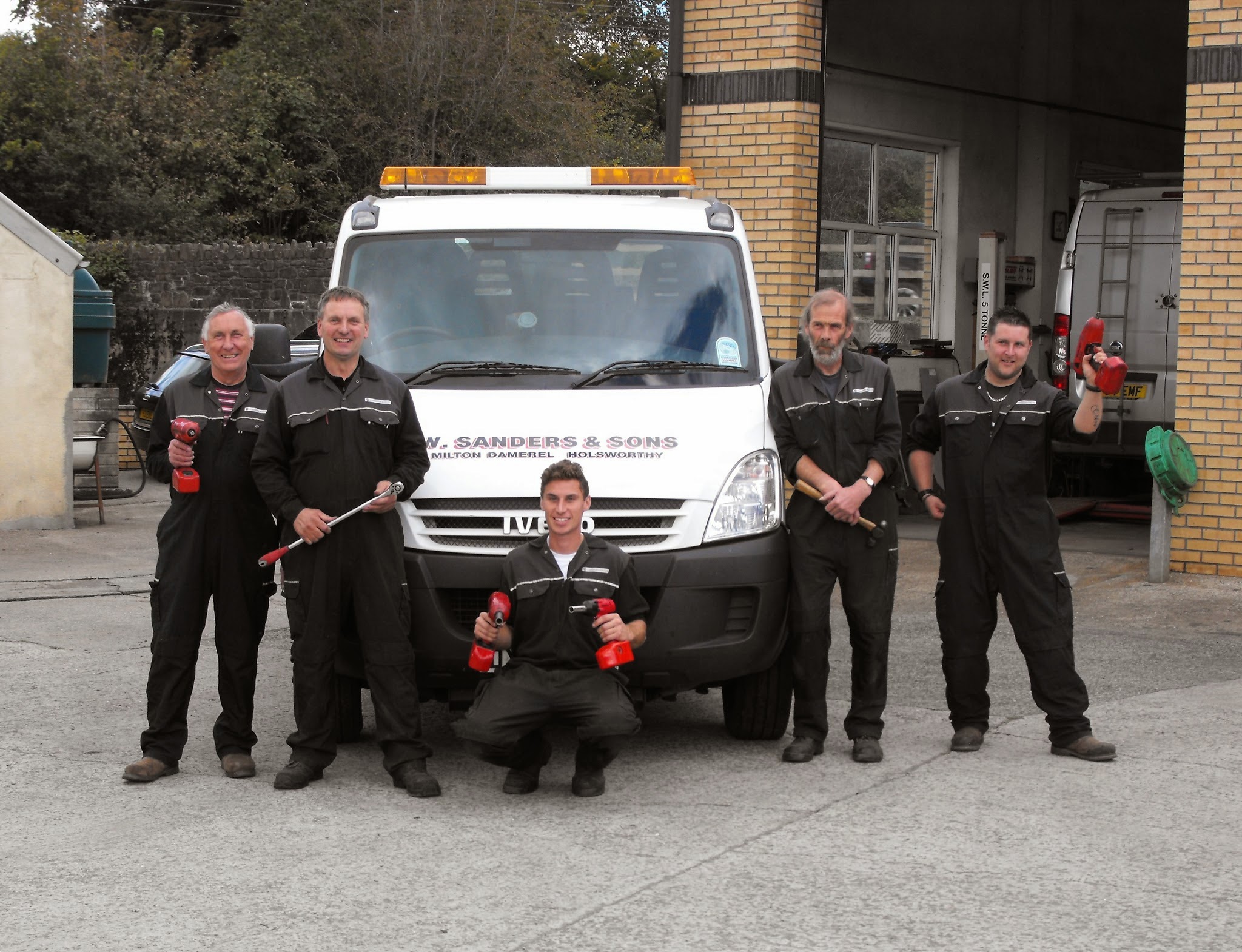 The W Sanders & Sons mechanics in their overalls in front of the recovery truck